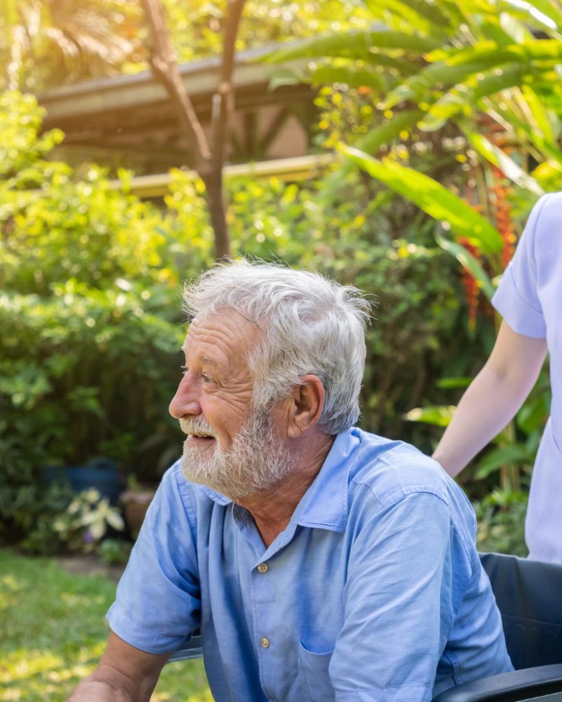 happy-nurse-take-care-elderly-man-wheelchair-garden-nursing-home